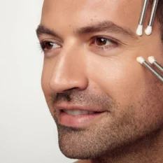 male client having CACI facial with micro-current probes