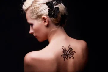 A blonde woman with large tattoo on her back