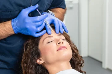 A woman having a Botox wrinkle relaxant injection treatment in her forehead at The Skincare Centre