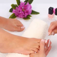 female client having french pedicure at beauty salon