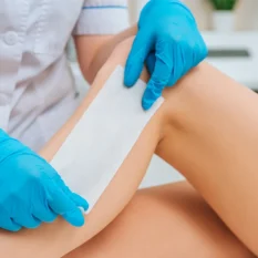female client having leg waxed at salon
